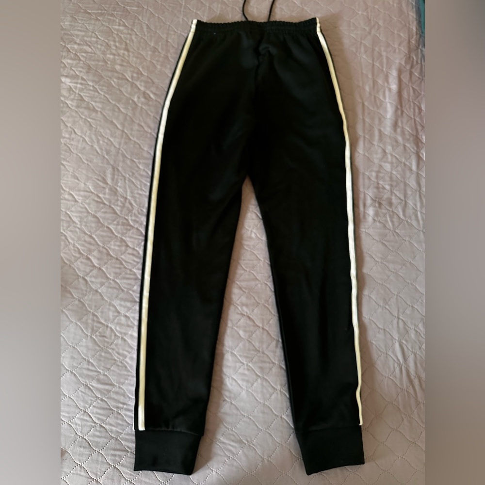 Black adidas track pants with white stripes
